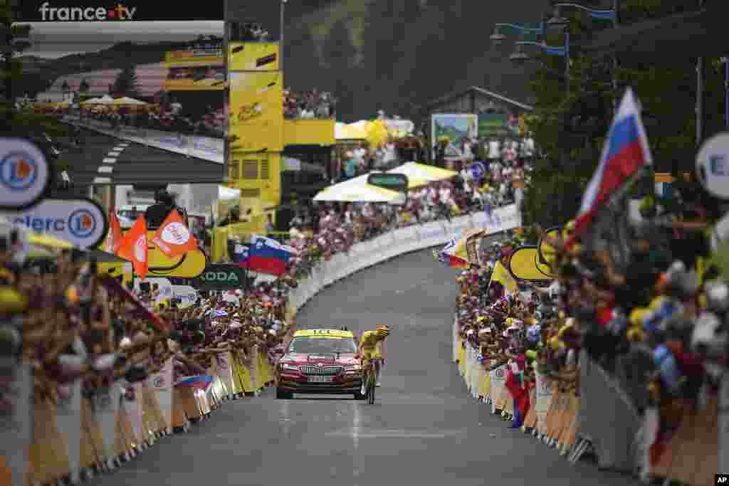 Stage winner Slovenia's Tadej Pogacar turns back to see if he has enough lead as he approaches the finish line of the 19th stage of the Tour de France cycling race over 144.6 kilometers (89.9 miles) with start in Embrun and finish in Isola 2000, France.