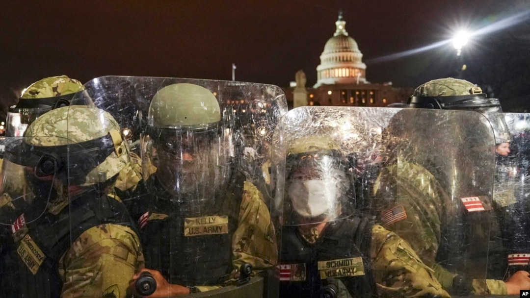 FILE - District of Columbia National Guard stand outside the Capitol, Jan. 6, 2021, after a day of rioting protesters.