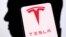 Logo Tesla dan siluet Elon Musk terlihat dalam sebuah ilustrasi, 19 Desember 2022. (Foto: REUTERS/Dado Ruvic)