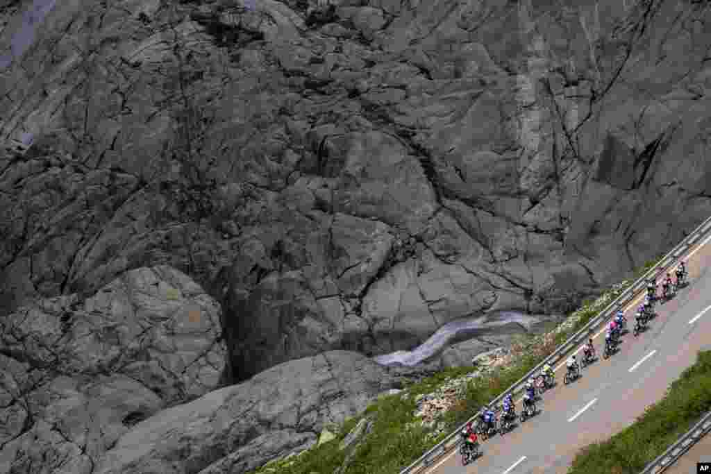 The pack climbs the Furka pass during the fifth stage, a 211-kilometer race from Fiesch to La Punt, of the 86th Tour de Suisse UCI World Tour cycling race in Goms, Switzerland.