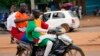 Nigeriens with Russian and Nigerien flags head for an anti-French protest in Niamey, Niger, Aug. 11, 2023.The ECOWAS bloc said it had directed a force to restore constitutional order in Niger after its deadline to reinstate the ousted leader expired.