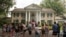 FILE - Fans wait outside Graceland, Aug. 15, 2017, in Memphis, Tenn. The granddaughter of Elvis is fighting plans to publicly auction his Graceland estate after a company tried to sell the property based on claims that a loan was not repaid.