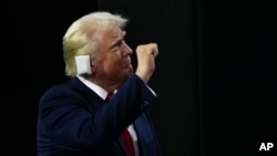 Republican presidential candidate former president Donald Trump gestures during the Republican National Convention, in Milwaukee, July 15, 2024.