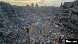 Palestinians search for casualties at the site of Israeli strikes on houses in Jabalia refugee camp in the northern Gaza Strip, Oct. 31, 2023. 