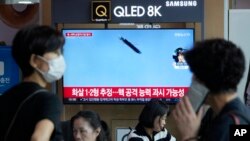 A TV screen shows a file image of North Korea's missile launch during a news program at the Seoul Railway Station in Seoul, South Korea, Sept. 2, 2023.