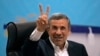 Iran's former President Mahmoud Ahmadinejad flashes a victory sign as he registers his name as a candidate for the June 28 presidential election at the Interior Ministry, in Tehran, Iran, June 2, 2024. 