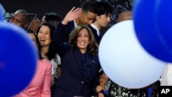 Democratic presidential nominee Vice President Kamala Harris waves surrounded by balloons at the Democratic National Convention, Aug. 22, 2024, in Chicago. 