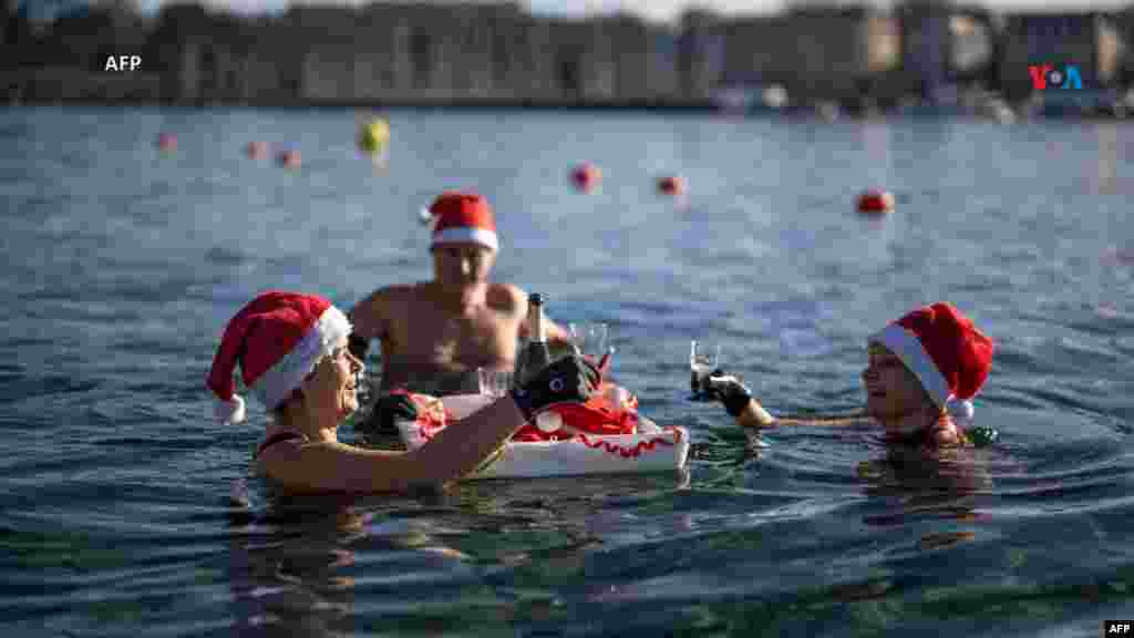 Desde Suiza: Con gorros de Papá Noel, varias personas se bañan y beben en un lago de Ginebra, a 8 grados Celsius en los baños públicos &#39;Bains des Paquis&#39;, en el centro de Ginebra, durante la víspera del día de Navidad, el 24 de diciembre de 2023.