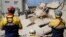 FILE - Rescue workers search the site of a building collapse in George, South Africa, May 8, 2024. Rescue teams are searching for dozens of construction workers missing after a multi-story apartment complex collapsed.