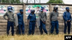 FILE - Zimbabwe Republic Police line up to block Citizens Coalition for Change from holding an election campaign rally at Rudhaka Stadium in Marondera, on March 12 2022. 