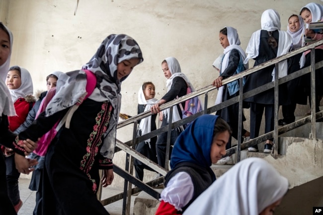 FILE - Girls attend school on the first day of the new school year, in Kabul, Afghanistan, on Saturday, March 25, 2023. (AP Photo/Ebrahim Noroozi)