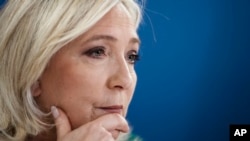 FILE - French far-right presidential candidate Marine Le Pen gives a press conference, in Paris, France on Thursday, December 2, 2021.