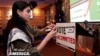 Natalia Latif with a 'Vote Uncommitted' sign during an uncommitted vote election night gathering in Dearborn, Michigan, February 27, 2024. 