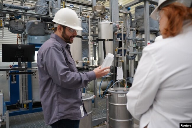 Air Company co-founder and chief technology officer Stafford Sheehan demonstrates the firm's patented system for converting carbon dioxide and hydrogen gas. (Air Company/Handout via REUTERS)