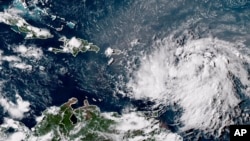 This GOES-16 GeoColor satellite image taken at 4:30 p.m. EDT and provided by National Oceanic and Atmospheric Administration shows Tropical Storm Ernesto over the Atlantic Ocean and moving west-northwest toward the Lesser Antilles, Aug. 12, 2024. 