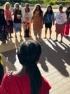 FILE - Supporters of a lawsuit challenging a Hawaii midwife licensure law gather outside a courthouse in Honolulu, June 10, 2024.