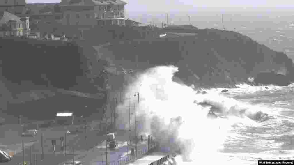 Waves crash over cars along the Promenade coastal road as Storm Kathleen makes its way through the British Isles, in Douglas, Isle of Man, April 7, 2024, in this screen grab obtained from social media video.