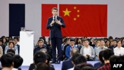 FILE - French President Emmanuel Macron gestures as he speaks to students at Sun Yat-sen University in Guangzhou, April 7, 2023, during his visit to China.