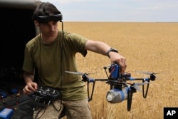 FILE - A Ukrainian serviceman operates a drone on the front line in Zaporizhzhia region, Ukraine, June 14, 2024.