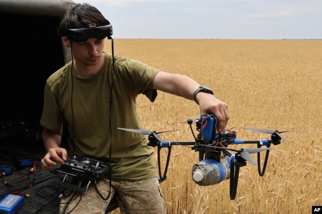 FILE - A Ukrainian serviceman operates a drone on the front line in Zaporizhzhia region, Ukraine, June 14, 2024.