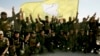 FILE - U.S.-backed Syrian Democratic Forces fighters pose for a photo in Baghouz, Syria, March 23, 2019. Violence between the SDF and one of its affiliates in the eastern province of Deir al-Zour erupted on Aug. 28, 2023.