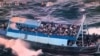 Potongan gambar dari sebuah video yang dirilis pada 11 Maret 2023 ini menunjukkan sebuah kapal yang disesaki oleh para migran terombang-ambing di lepas pantai Calabria, Italia, pada 10 Maret 2023. (Foto: Handout/Guardia Costiera/AFP)