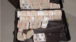 A suitcase filled with cash is shown on the website of Singapore police. In raids in mid-August, authorities seized close to three quarters of a billion U.S. dollars in assets, including more than 100 luxury condos and dozens of flashy cars.