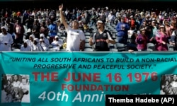 FILE - In this photo taken June 11, 2016 church members pray for victims of the June 1976 uprising as they prepare to march to mark the 40th anniversary in Soweto, South Africa. (AP Photo/Themba Hadebe, File)