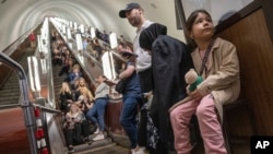 People take cover at metro station during a Russian rocket attack in Kyiv, Ukraine, May 29, 2023. Explosions have rattled Kyiv during daylight as Russian ballistic missiles fell on the Ukrainian capital.