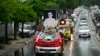 A hearse carrying the coffin of the late Myanmar general turned democracy activist Tin Oo makes its way to the cemetery during his funeral in Yangon, June 5, 2024. 