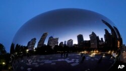 FILE - Chicago's skyline is reflected on Anish Kapoor's stainless steel sculpture Cloud Gate, also known as "The Bean," in the city's Millennium Park, May 25, 2023. 