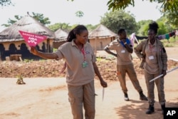 Staff from the Mines Advisory Group (MAG) teach children about the risks of unexploded mines, in Moli village, Eastern Equatoria state, in South Sudan Friday, May 12, 2023. (AP Photo/Sam Mednick)