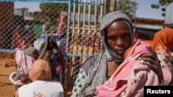 FILE - A MSF handout photograph from January 2024 shows a woman and baby at the Zamzam displacement camp, close to El Fasher in North Darfur, Sudan.