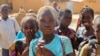 FILE- Balkissa Barro, 10, center, walks to school with friends in the Burkina Faso village of Dori, Burkina Faso, Oct. 20, 2020.