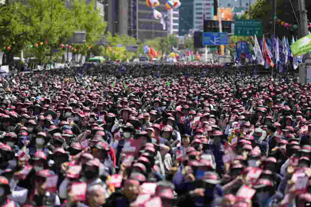 Members of the Korean Confederation of Trade Unions shout slogans during a rally on May Day in Seoul, South Korea.