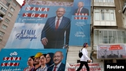 A person walks past election campaign billboards of Kemal Kilicdaroglu, presidential candidate of Turkey's main opposition alliance ahead of the May 28 runoff vote, in Ankara, Turkey, May 26, 2023.