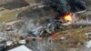 ARCHIVO - En esta foto tomada con un dron, partes de un tren de carga de Norfolk Southern que descarriló la noche anterior en East Palestine, Ohio, permanecen en llamas al mediodía del 4 de febrero de 2023.