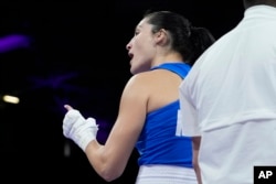 Italy's Angela Carini speaks with her team after abandoning her fight against Algeria's Imane Khelif in their women's 66kg preliminary boxing match at the 2024 Summer Olympics, Aug. 1, 2024, in Paris.