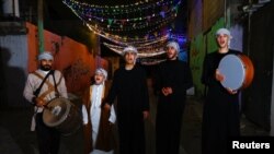 Kelompok Mesaharati Palestina membangunkan umat Islam untuk sahur selama bulan suci Ramadan, di Khan Younis, Jalur Gaza selatan, 25 Maret 2023. (REUTERS/Ibraheem Abu Mustafa)