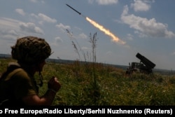 FILE - Ukrainian servicemen fire a BM-21 Grad multiple launch rocket system towards Russian troops near a front line in Zaporizhzhia region, June 25, 2023.