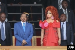 FILE - Cameroon President Paul Biya and his wife Chantal Biya react during the May 20 parade marking the 52nd celebration of Unity Day in Yaounde on May 20, 2024.