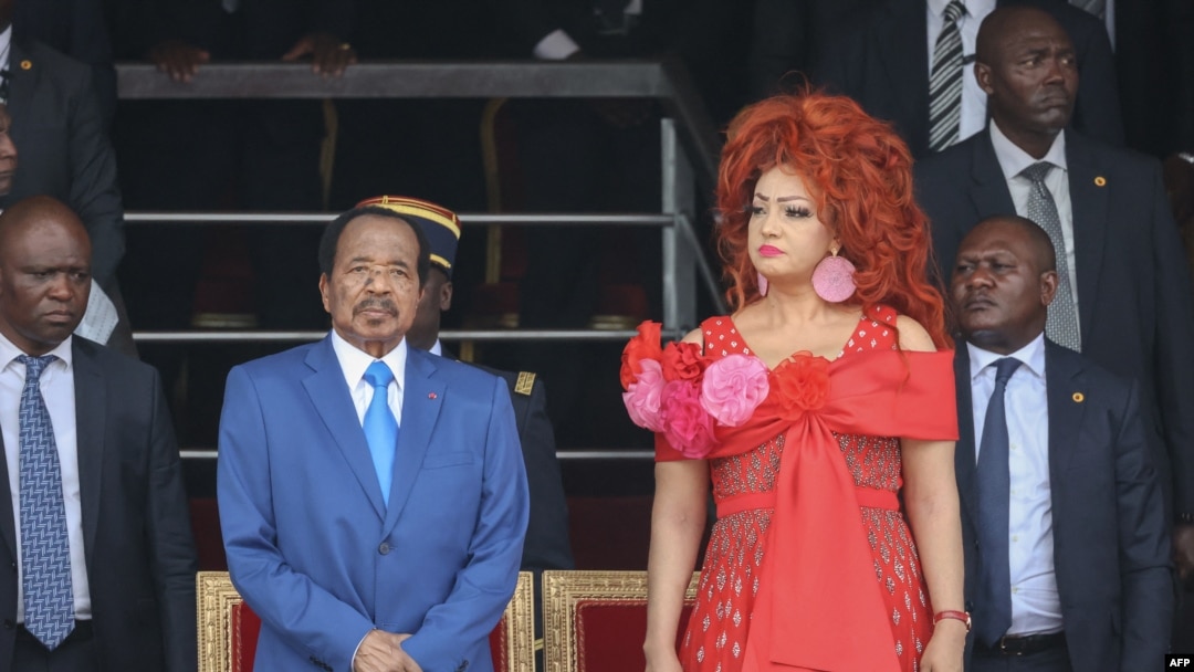 FILE - Cameroon President Paul Biya and his wife Chantal Biya attend the May 20 parade marking the 52nd celebration of Unity Day in Yaounde, May 20, 2024. Brenda Biya, the daughter of President Biya, declared she is a lesbian.