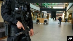A Serbian special police officer patrols at a shopping mall in Belgrade, Serbia, March 25, 2024. Serbian government increased its security alert posture after the deadly attack at a Russian concert hall.