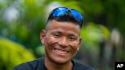 FILE - Nepalese mountain guide Tenjen Sherpa, 35, smiles during an interview with the Associated Press in Kathmandu, Nepal, Aug. 9, 2023. Tenjen Sherpa and American climber Gina Marie Rzucidlo are reported missing after avalanches struck Tibet’s Mount Shishapangma, Oct. 7, 2023. 