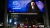FILE - Vehicles move underneath a billboard showing an ad for the Egyptian television series "al-Hashashin" (The Assassins) along a road in Cairo's eastern suburb of Heliopolis, March 3, 2024. Iran just banned the broadcast of the television series.