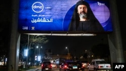 FILE - Vehicles move underneath a billboard showing an ad for the Egyptian television series "al-Hashashin" (The Assassins) along a road in Cairo's eastern suburb of Heliopolis, March 3, 2024. Iran just banned the broadcast of the television series.