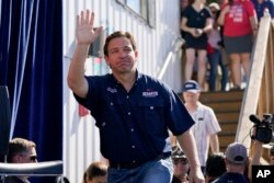 FILE - Republican presidential candidate Florida Gov. Ron DeSantis waves as he steps onto the stage at the Iowa State Fair, in Des Moines, Iowa, Aug. 12, 2023.