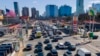 FILE - Commuters wait to drive through the Holland Tunnel into New York City in Jersey City, N.J., March 8, 2023. A study published May 22, 2024, says U.S. vehicles hit a record average age of 12.6 years in 2024.