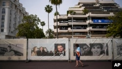 A person walks along the Croisette ahead of the Cannes film festival, in Cannes, southern France, May 12, 2024. The 77th edition of the film festival runs from May 14 until May 25. 