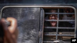 A protester screams as he is carried away with others after being arrested by military police during the anticorruption protest in Kampala, Uganda, July 23, 2024.